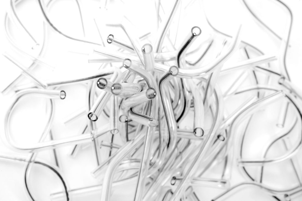 pile of clear linear reinforced tubes