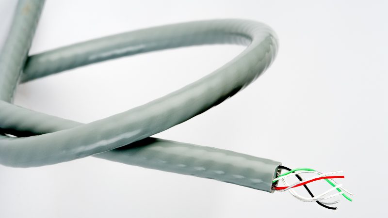 eTubing with gray jacket and 4 colored conductors emerging from the tube wall